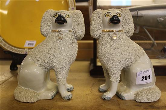 Pair of Staffordshire porcelaneous models of seated poodles